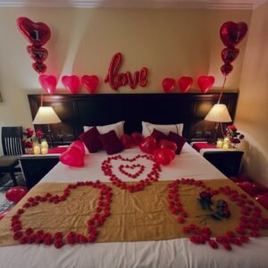 Romantic Room Decoration with red balloons and rose petal heart on bed.